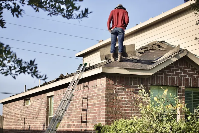 Professional roofer working on a residential roof in Felida